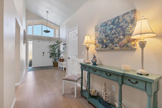 entryway featuring light hardwood / wood-style flooring and high vaulted ceiling