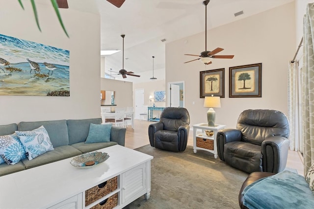 carpeted living room with high vaulted ceiling