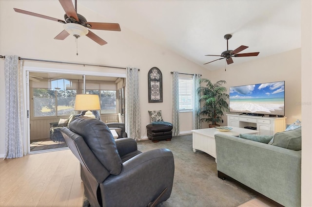 living room with ceiling fan, vaulted ceiling, and light hardwood / wood-style flooring