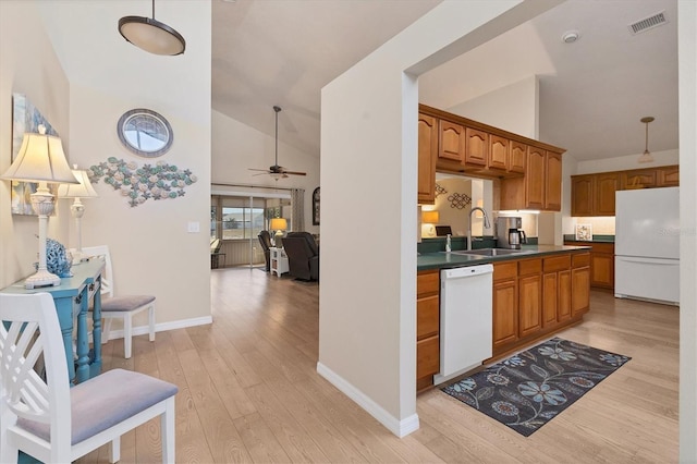 kitchen featuring white appliances, high vaulted ceiling, light hardwood / wood-style floors, and sink