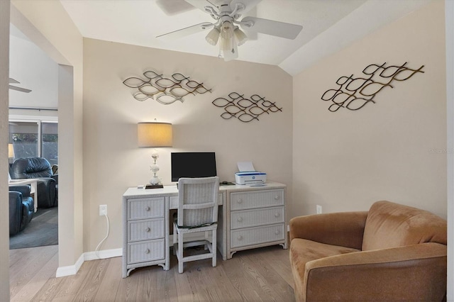 office area featuring vaulted ceiling, ceiling fan, and light wood-type flooring