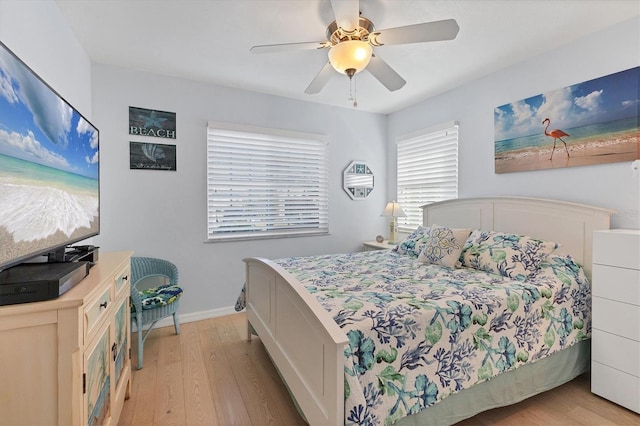 bedroom with light hardwood / wood-style floors and ceiling fan