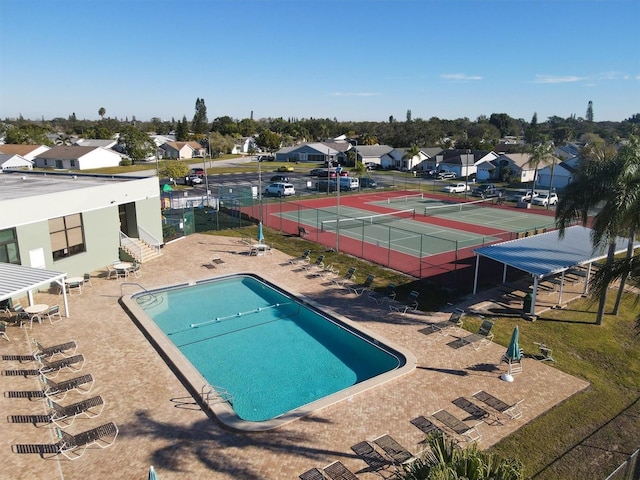 view of swimming pool with tennis court