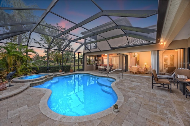 pool at dusk with an in ground hot tub, a lanai, and a patio