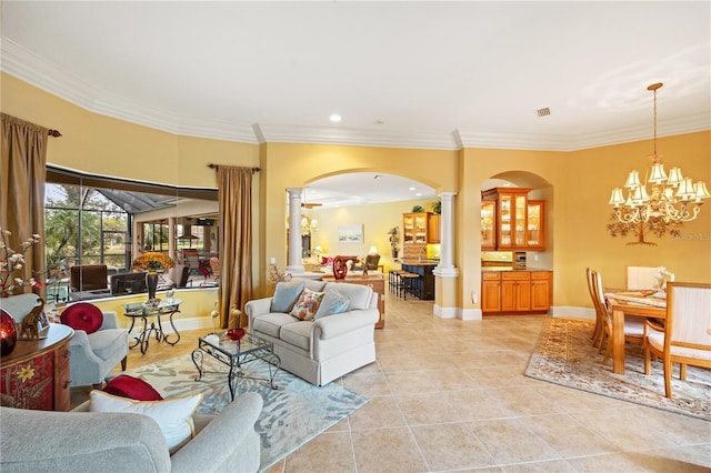 living room featuring decorative columns, ornamental molding, light tile patterned floors, and a notable chandelier