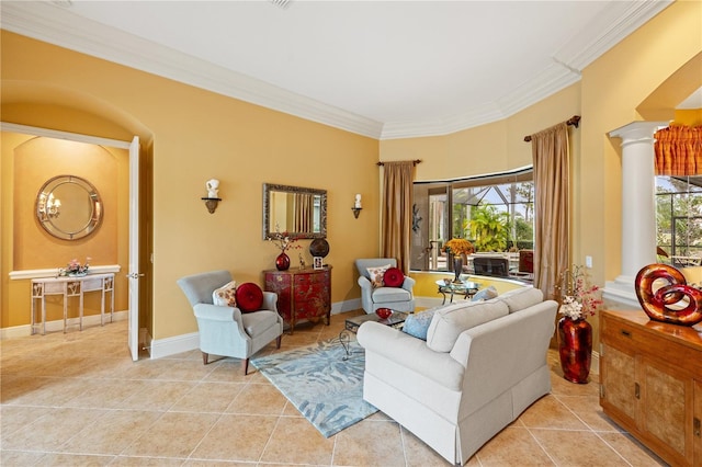 tiled living room featuring plenty of natural light, ornamental molding, and ornate columns