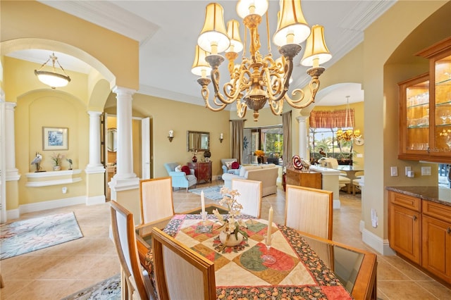 dining space with ornate columns, ornamental molding, light tile patterned floors, and a notable chandelier