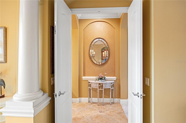 hall with decorative columns, light tile patterned flooring, and crown molding