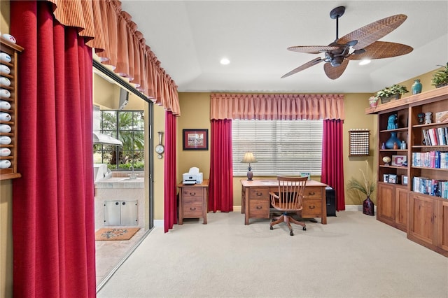 carpeted home office featuring ceiling fan and a wealth of natural light