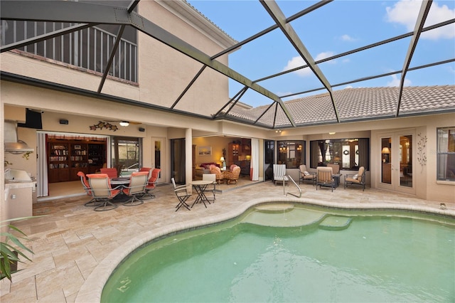 rear view of property featuring outdoor lounge area, a patio area, and a lanai