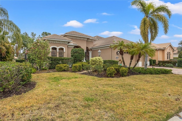 mediterranean / spanish-style home with a front yard