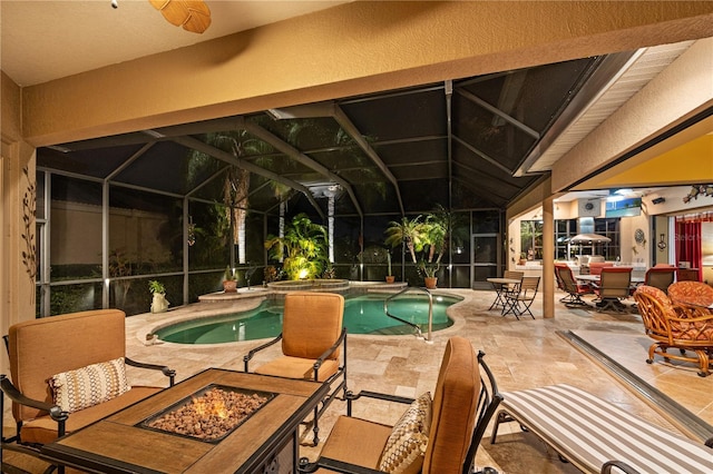 view of swimming pool with a fire pit, a lanai, a patio, and an in ground hot tub