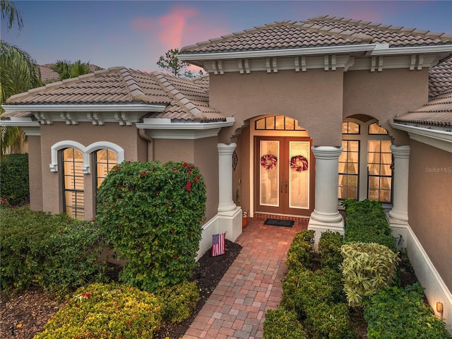 exterior entry at dusk with french doors