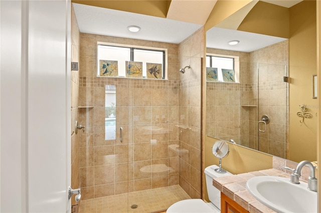 bathroom with walk in shower, vanity, and toilet