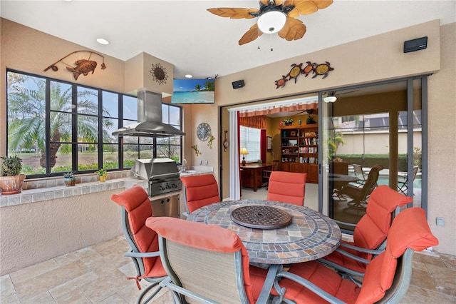 sunroom with ceiling fan and sink