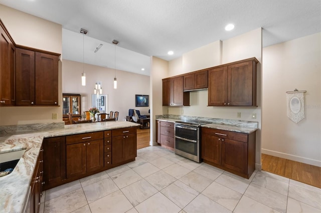 kitchen featuring pendant lighting, light stone countertops, kitchen peninsula, and range with two ovens