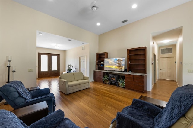 living room featuring french doors and light wood-type flooring