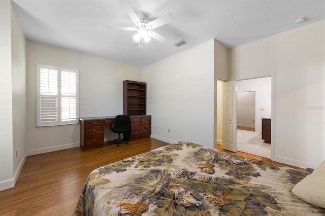 bedroom with connected bathroom, ceiling fan, and light wood-type flooring