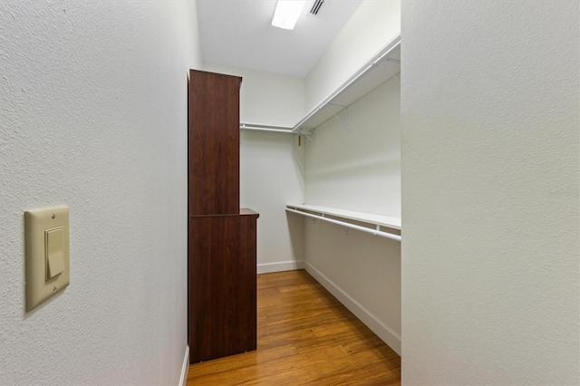 spacious closet with light hardwood / wood-style floors