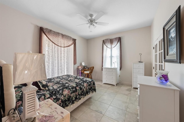 tiled bedroom featuring ceiling fan