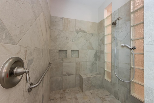 bathroom with a tile shower