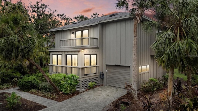 property exterior at dusk with a balcony