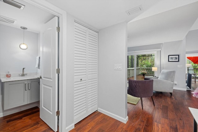 hallway with dark wood-type flooring and sink