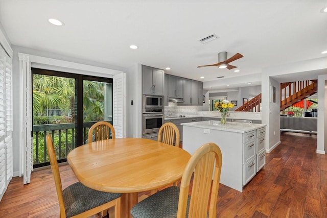 dining room featuring dark wood-type flooring and ceiling fan