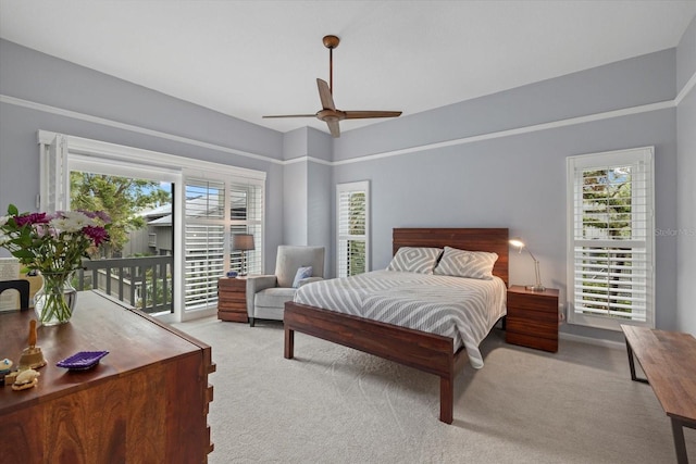 carpeted bedroom featuring ceiling fan, access to exterior, and multiple windows