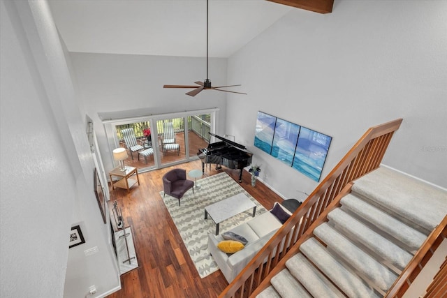 living room with hardwood / wood-style flooring, ceiling fan, high vaulted ceiling, and beam ceiling