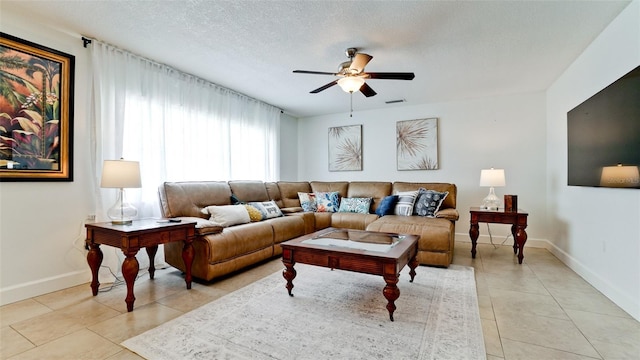 tiled living room featuring ceiling fan and a textured ceiling