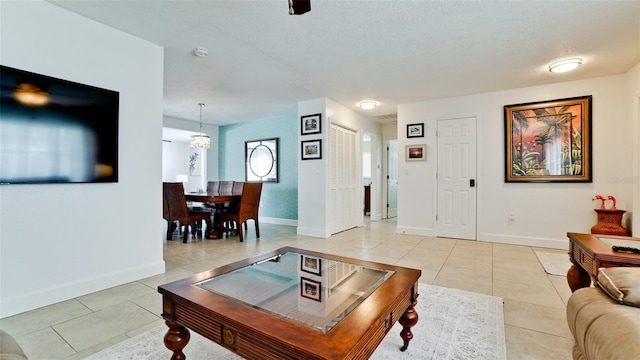 tiled living room featuring a textured ceiling