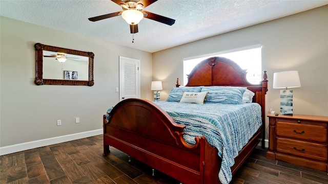 bedroom featuring ceiling fan, dark hardwood / wood-style floors, and a textured ceiling