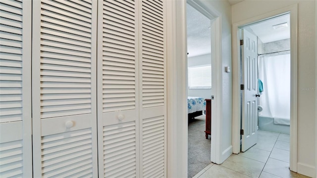 corridor with light tile patterned floors