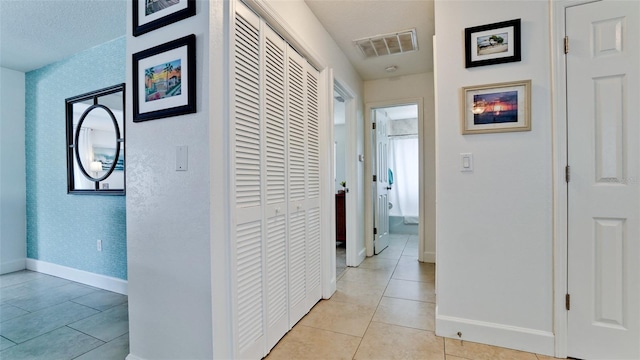 corridor with light tile patterned floors