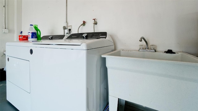 clothes washing area with sink and washer and dryer