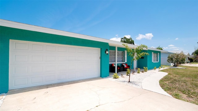 single story home with a garage and a front lawn