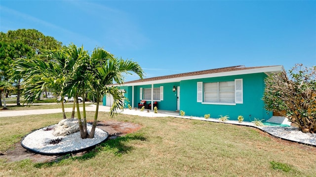 ranch-style house with a front lawn