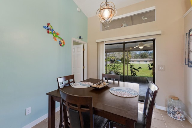 tiled dining room with high vaulted ceiling