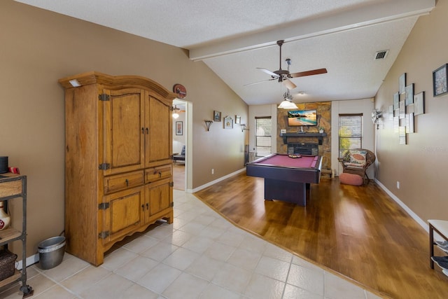 recreation room featuring billiards, a fireplace, a textured ceiling, and vaulted ceiling with beams