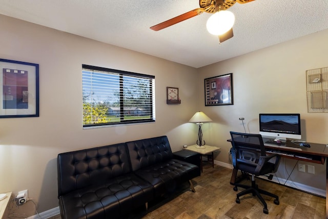 office area with ceiling fan, wood-type flooring, and a textured ceiling