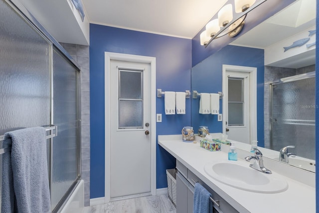 bathroom featuring vanity and shower / bath combination with glass door