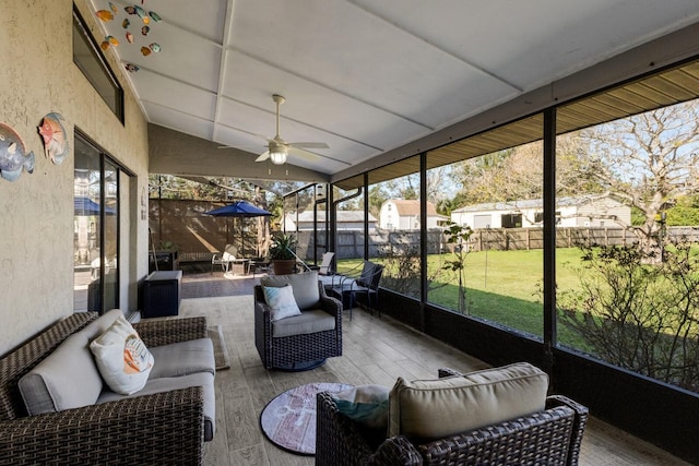 sunroom / solarium featuring ceiling fan