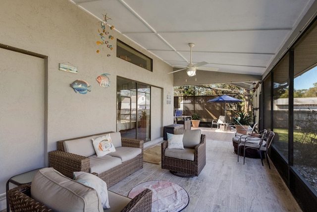 sunroom / solarium with ceiling fan and vaulted ceiling