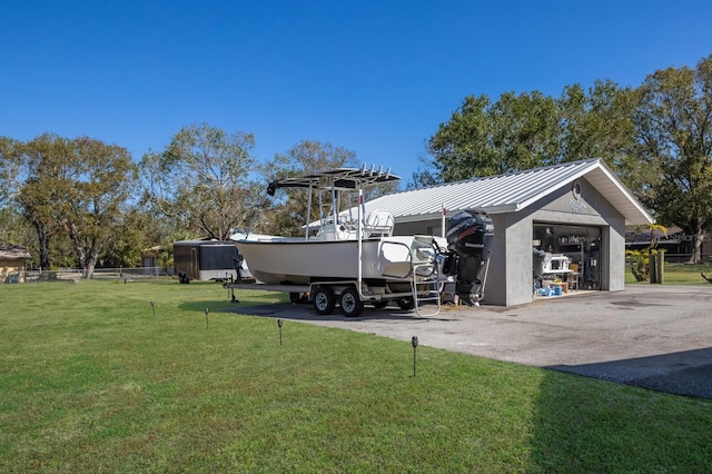 exterior space featuring a garage and a lawn