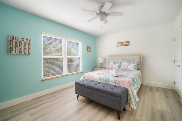 bedroom with light hardwood / wood-style flooring and ceiling fan