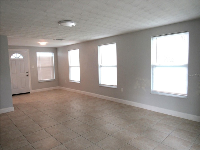 entryway featuring light tile patterned flooring and a wealth of natural light