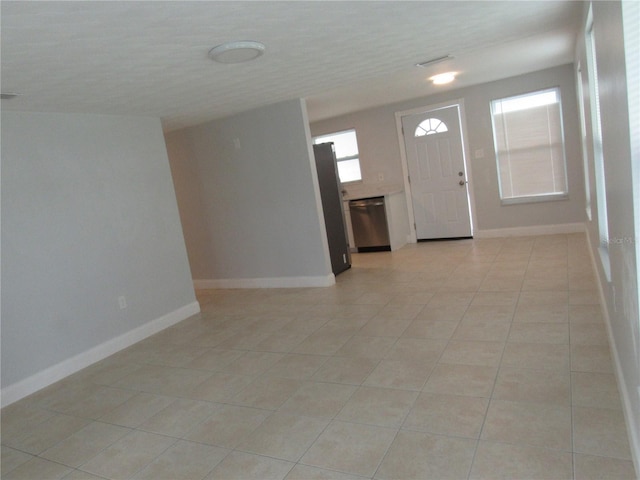 entrance foyer featuring light tile patterned floors and a textured ceiling