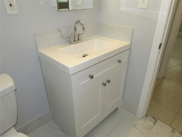 bathroom with vanity and toilet