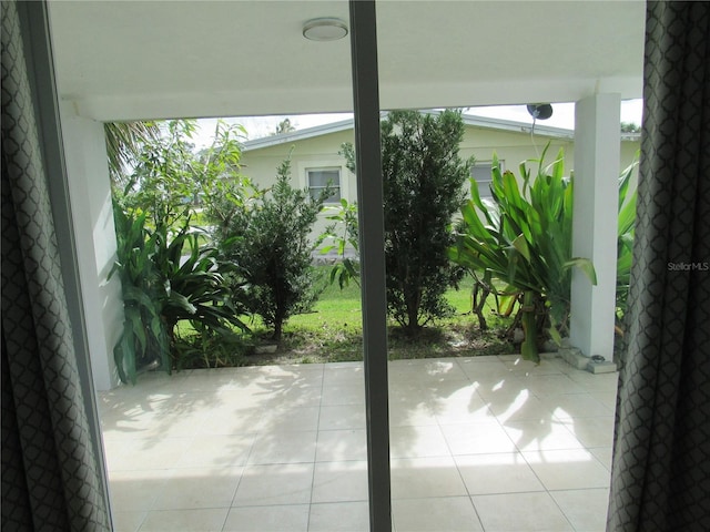 doorway with light tile patterned flooring